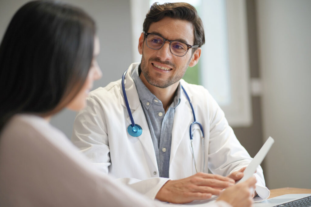 Young doctor talking with female patient